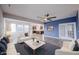 Living room with sofas, coffee table, kitchen view, wood floors, and lots of light at 2628 Lamar Dr, Whitestown, IN 46075