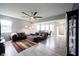 Spacious living room with stylish decor, a ceiling fan, and an open floor plan leading to the dining area at 2628 Lamar Dr, Whitestown, IN 46075