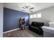 Inviting loft area featuring a comfortable leather sofa, fun arcade game, and three pane windows at 2628 Lamar Dr, Whitestown, IN 46075