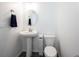 Clean powder room with white pedestal sink, oval mirror, and a toilet at 2628 Lamar Dr, Whitestown, IN 46075
