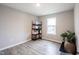 This room features wood flooring, a window, and a shelving unit for storage and is well-lit at 2628 Lamar Dr, Whitestown, IN 46075