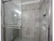 Elegant walk-in shower featuring stone-look tiles and modern fixtures at 2628 Lamar Dr, Whitestown, IN 46075