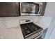 Close-up of the stainless stove and oven with subway tile backsplash at 2628 Lamar Dr, Whitestown, IN 46075