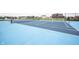 Community tennis court with a blue surface, net, and fencing, offering recreational opportunities at 2628 Lamar Dr, Whitestown, IN 46075
