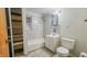 Bathroom with a tiled shower over tub, vanity, and a toilet at 268 S Grant Ave, Indianapolis, IN 46201