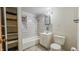 Bathroom with tiled shower-tub combo, vanity, and toilet at 268 S Grant Ave, Indianapolis, IN 46201