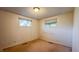 Bedroom with two windows providing natural light and carpet flooring at 268 S Grant Ave, Indianapolis, IN 46201
