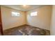 Bedroom with two windows and damaged floors needs renovation at 268 S Grant Ave, Indianapolis, IN 46201