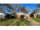 Charming brick ranch-style home featuring a well-maintained lawn and mature trees at 268 S Grant Ave, Indianapolis, IN 46201