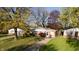 Charming ranch-style home nestled among mature trees with a well-maintained front lawn at 268 S Grant Ave, Indianapolis, IN 46201