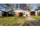 A quaint ranch style house with brick and vinyl siding, surrounded by green lawns at 268 S Grant Ave, Indianapolis, IN 46201