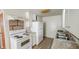 A compact kitchen featuring white appliances, cabinets, and tile flooring at 268 S Grant Ave, Indianapolis, IN 46201