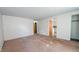 Open living room with carpet flooring, view of the kitchen, and ample natural light at 268 S Grant Ave, Indianapolis, IN 46201