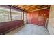 Enclosed sunroom with concrete floor and red painted accents at 268 S Grant Ave, Indianapolis, IN 46201