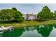 Stunning aerial view of a lakefront community with charming gray townhomes, private docks, and lush landscaping at 2823 Somerset Bay, Indianapolis, IN 46240