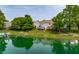 Scenic aerial view of a lakefront community with gray siding, lush trees, private docks, and waterfront access at 2823 Somerset Bay, Indianapolis, IN 46240