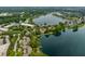 Expansive aerial view showcases lakefront homes nestled in a serene community surrounded by mature trees and lush greenery at 2823 Somerset Bay, Indianapolis, IN 46240