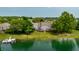 Aerial view of a gray townhome community on a lake with lush landscaping and private docks at 2823 Somerset Bay, Indianapolis, IN 46240