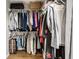 Walk-in closet featuring a variety of hanging clothes, shelving and laminate wood-look flooring at 2823 Somerset Bay, Indianapolis, IN 46240