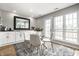 Bright dining area with glass table, white chairs, windows and white sideboard at 2823 Somerset Bay, Indianapolis, IN 46240