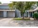 Charming townhome with grey wood siding, grey garage door, and inviting front yard landscaping at 2823 Somerset Bay, Indianapolis, IN 46240