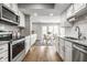 Bright kitchen with white cabinets, stainless steel appliances, and a dining area with a glass table at 2823 Somerset Bay, Indianapolis, IN 46240