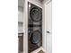 Contemporary stacked washer and dryer unit with stainless steel accents is energy efficient and modern at 2823 Somerset Bay, Indianapolis, IN 46240