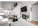 Bright living room featuring a fireplace, staircase, and a comfortable grey sofa at 2823 Somerset Bay, Indianapolis, IN 46240