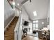 Bright living room featuring a skylight, fireplace, and staircase at 2823 Somerset Bay, Indianapolis, IN 46240
