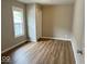 Cozy bedroom with light-colored walls, wood flooring, and natural light from a large window at 2924 Main St, Anderson, IN 46016