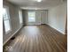 Bright living room featuring modern flooring, fresh paint, and natural lighting at 2924 Main St, Anderson, IN 46016