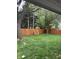 Large backyard with a new wooden fence and mature trees offers a private outdoor space at 2935 Flintwood Dr, Columbus, IN 47203
