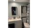 Well-lit bathroom features a sink and cabinet with sliding door cabinet and decorative shower curtain at 2935 Flintwood Dr, Columbus, IN 47203