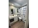 Well-lit bathroom featuring a single sink vanity, toilet, and shower with a stylish blue-patterned curtain at 2935 Flintwood Dr, Columbus, IN 47203