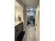 Updated bathroom boasts modern vanity and hexagon tiled floor, plus laundry area at 2935 Flintwood Dr, Columbus, IN 47203