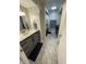 Bathroom with updated vanity, hexagon tiled floor, and shower and laundry in the background at 2935 Flintwood Dr, Columbus, IN 47203