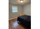 Cozy bedroom with hardwood floors, natural light, and a wooden chest at the end of the bed at 2935 Flintwood Dr, Columbus, IN 47203