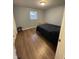 Bedroom featuring laminate wood flooring, a single window, and minimal furnishings at 2935 Flintwood Dr, Columbus, IN 47203
