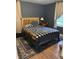 Relaxing bedroom featuring a comfortable bed, an accent rug, and natural light at 2935 Flintwood Dr, Columbus, IN 47203