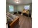 Cozy bedroom with hardwood flooring, natural light, and includes a bed, desk, and storage at 2935 Flintwood Dr, Columbus, IN 47203