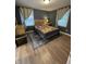 Cozy bedroom with hardwood floors, comfortable bed, and natural light from two windows at 2935 Flintwood Dr, Columbus, IN 47203