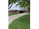 Charming brick ranch home with a well-maintained lawn and an attached two-car garage at 2935 Flintwood Dr, Columbus, IN 47203
