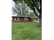 Beautiful one story home with mature trees, brick facade, and attached garage at 2935 Flintwood Dr, Columbus, IN 47203