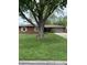 Lovely one story home with mature tree, brick facade, and a two-car garage at 2935 Flintwood Dr, Columbus, IN 47203