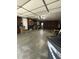 Functional garage space with built-in shelving, lighting, and room for parking and projects at 2935 Flintwood Dr, Columbus, IN 47203