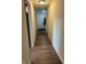 Inviting hallway with modern laminate flooring and neutral paint, leading to various rooms at 2935 Flintwood Dr, Columbus, IN 47203