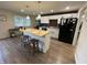 Open kitchen features a large island with seating, white cabinets, and stainless appliances at 2935 Flintwood Dr, Columbus, IN 47203