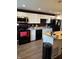 Modern kitchen featuring white cabinets, wood countertops, black appliances, and laminate floors at 2935 Flintwood Dr, Columbus, IN 47203