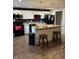 Modern kitchen featuring white cabinets, wood countertops, black appliances, and laminate floors at 2935 Flintwood Dr, Columbus, IN 47203