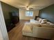 Spacious living room with wood-look flooring, a large sectional sofa, and bright window at 2935 Flintwood Dr, Columbus, IN 47203
